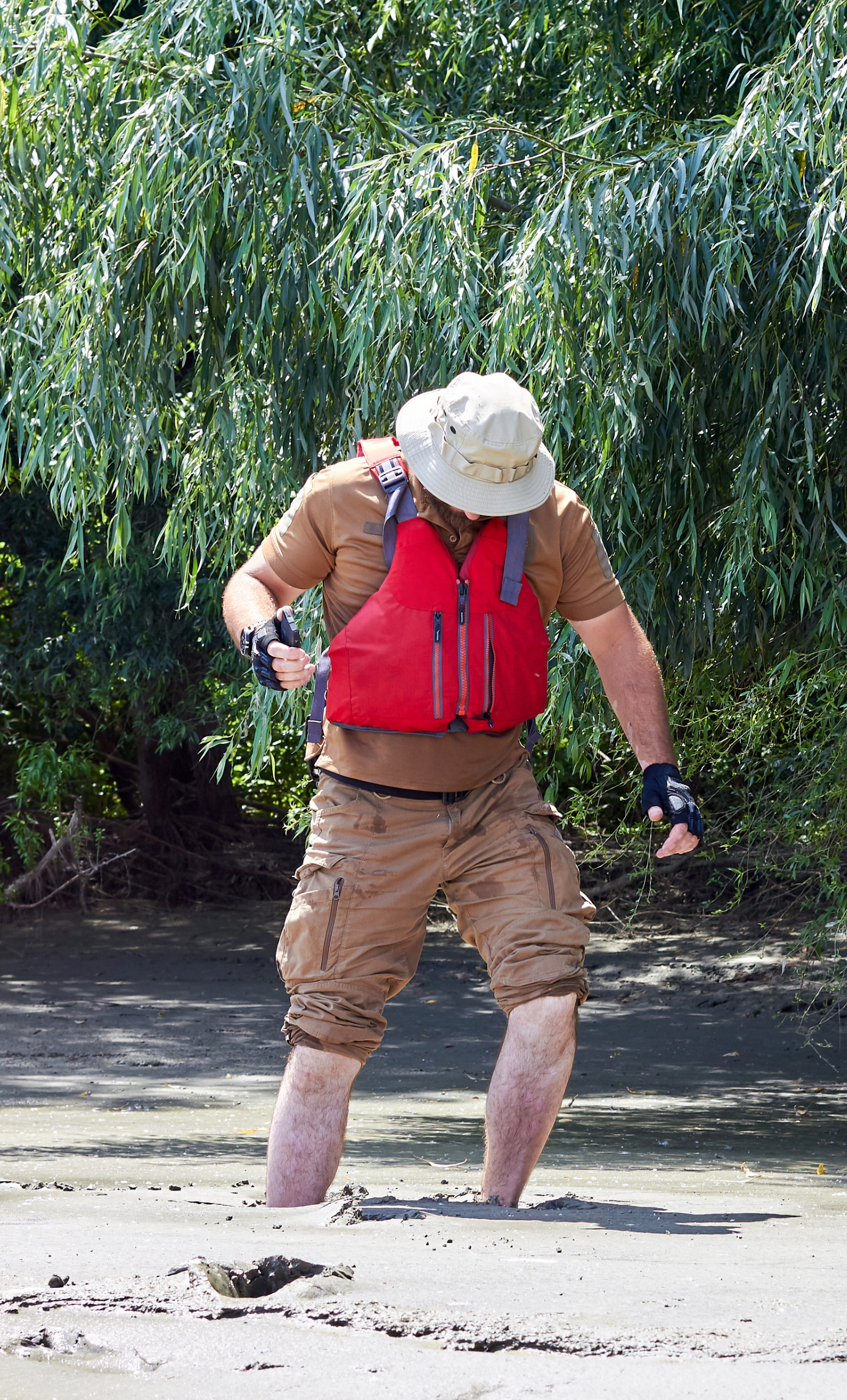 Image of man walking in quicksand that is midcalf deep, an example of a non-Newtonian fluid.